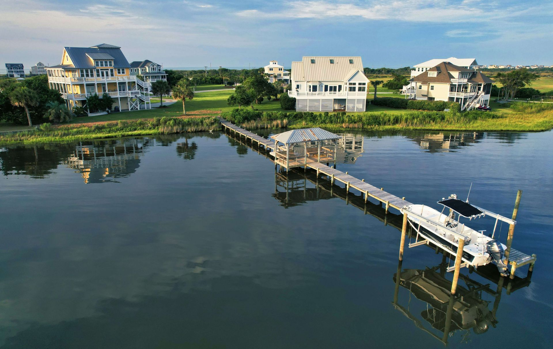 Boat lift holding a vessel above the water at a Hampton Roads dock